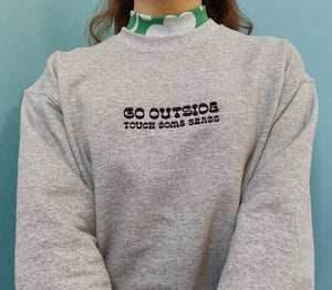 embroidered 'go outside' crew neck jumper