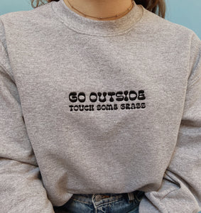 embroidered 'go outside' crew neck jumper